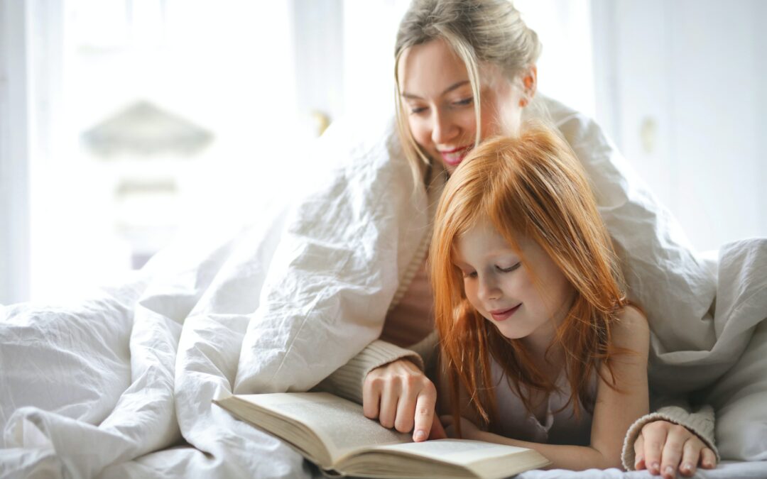 mom reading aloud to daughter