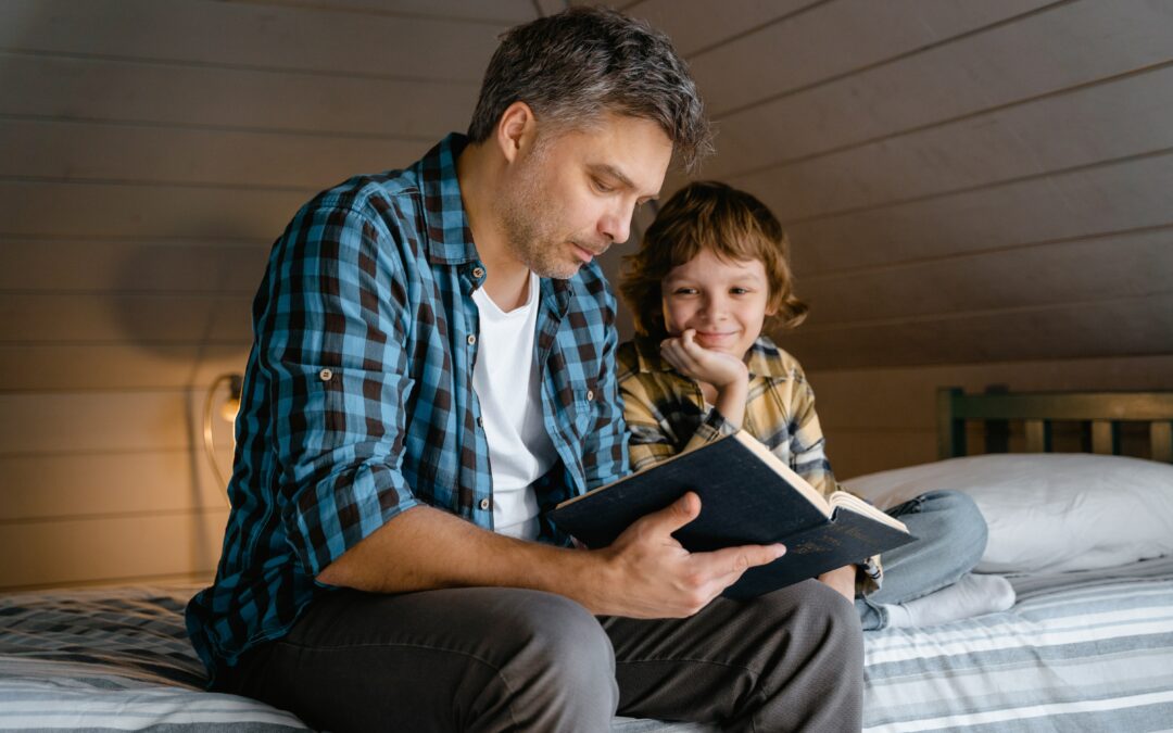 dad reading to son in bedroom