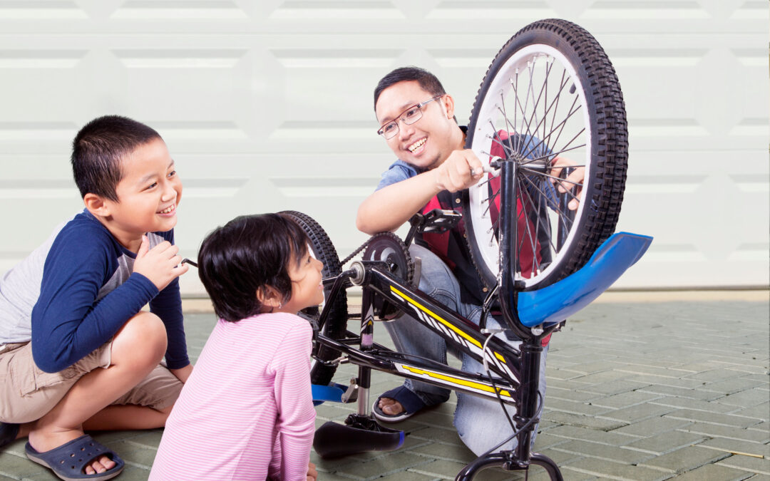 homeschool dad fixing bike with kids
