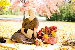 young woman with book in autumn