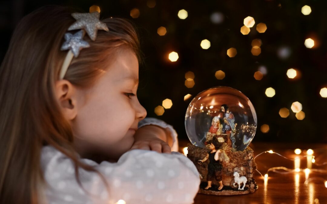 Girl with nativity globe