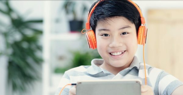 kid smiling while he's listening music