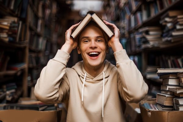 a guy with a book over his head