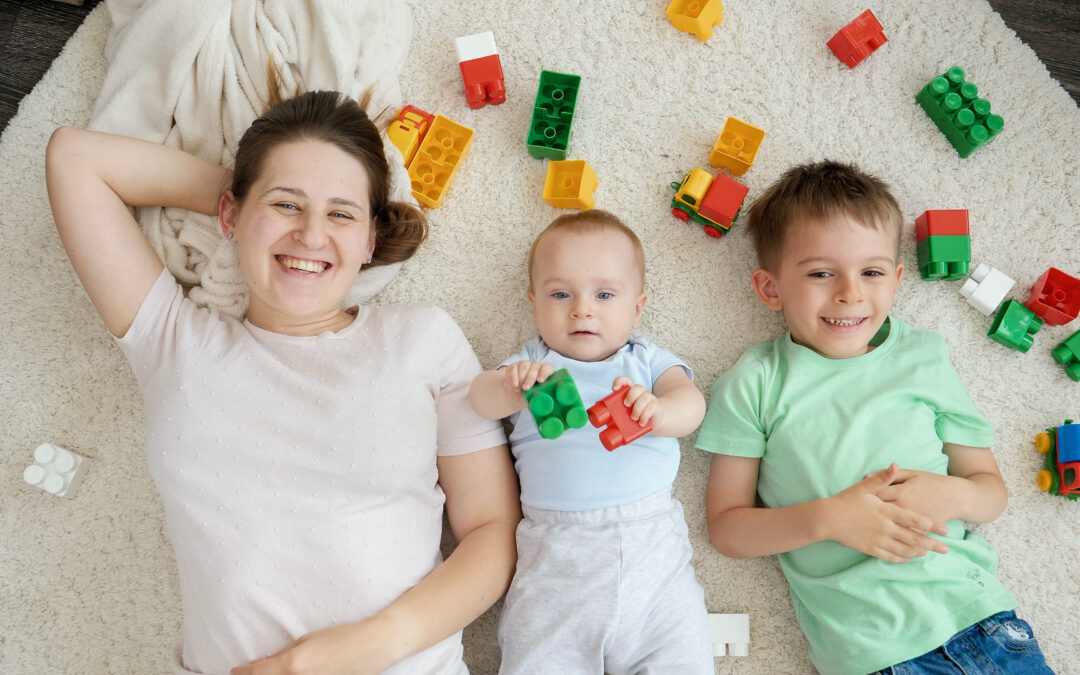 happy homeschool mom on floor with kids and legos