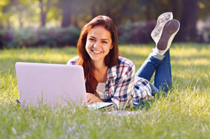 teenager outside on laptop homeschooling