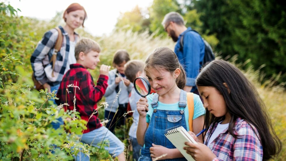 Homeschool children and parents doing outdoor studies