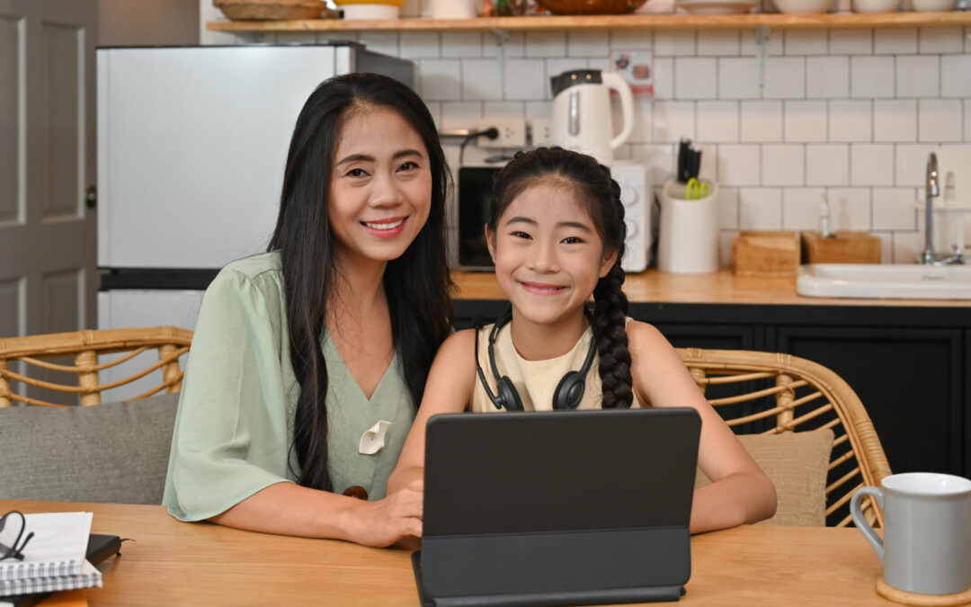 Homeschool mom and daughter in kitchen with tablet