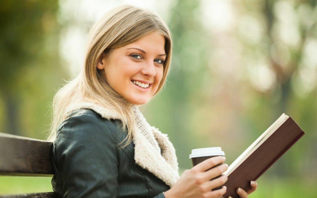 woman reading book drinking coffee