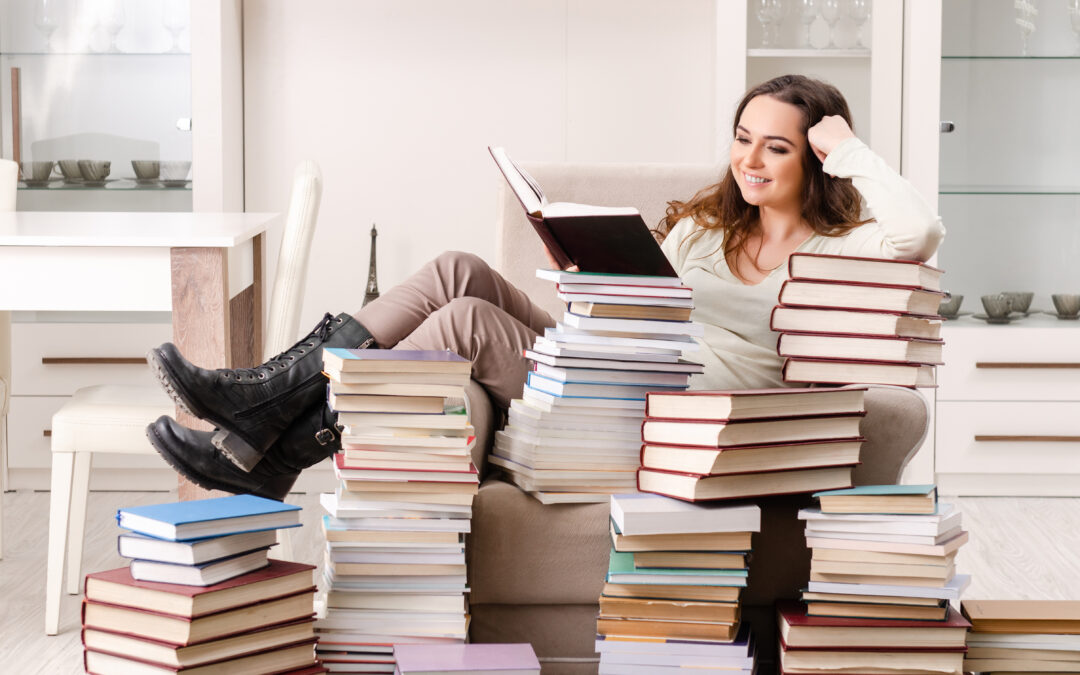 Woman in living room with stacks of books