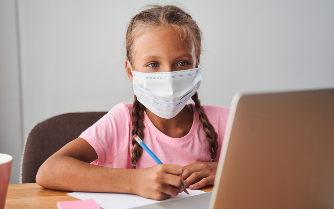 masked grade school girl at laptop