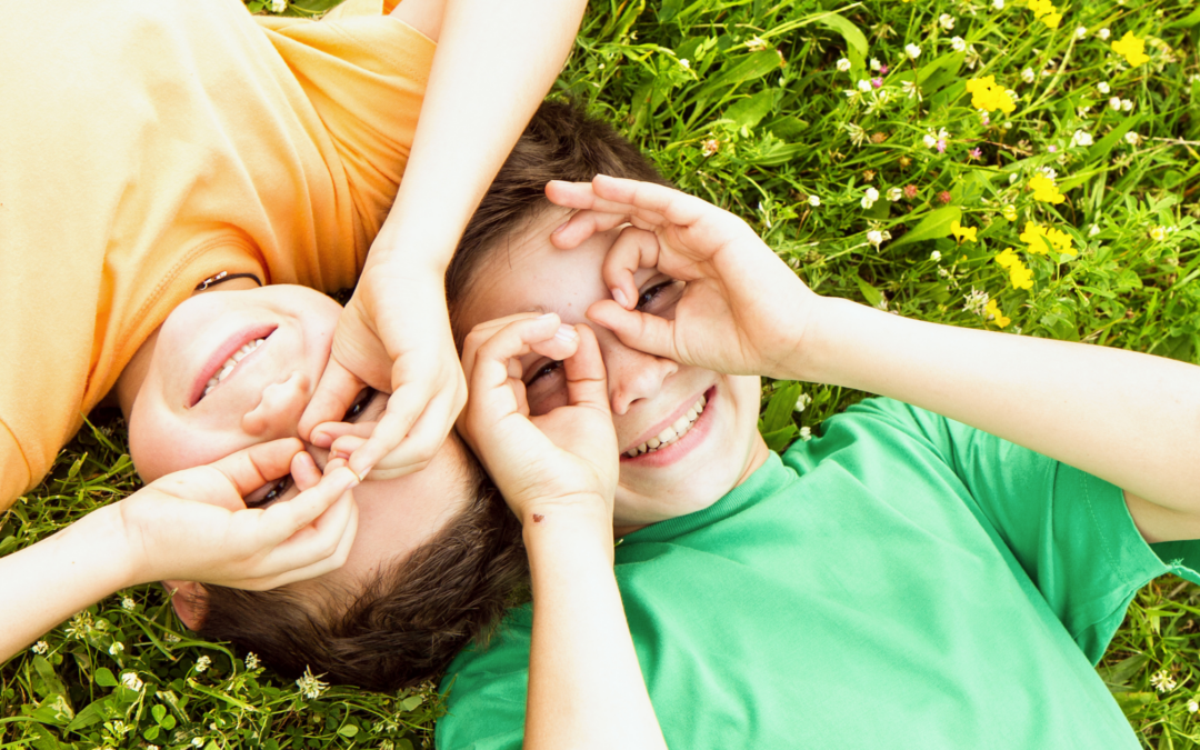 children laying in grass