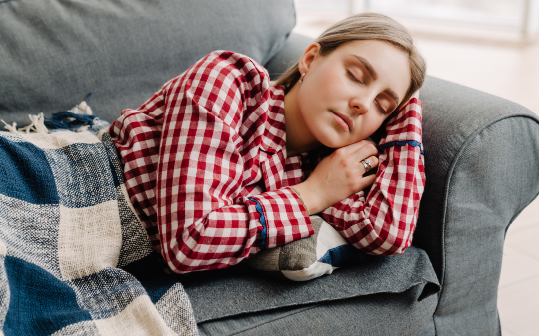 Catholic homeschool mom on couch in pajamas