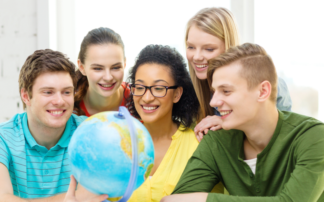 homeschool teens looking at a globe