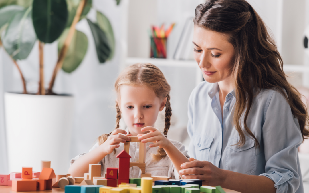 Catholic homeschool mom playing blocks with child