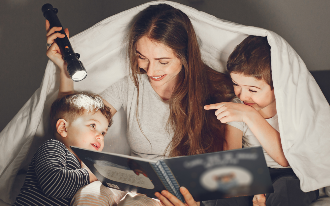 Catholic homeschool mom reading to her children in bed
