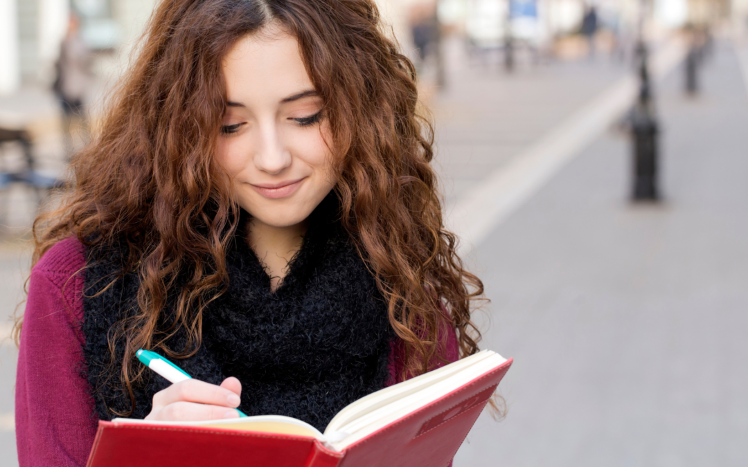 catholic homeschool teen girl writing in journal