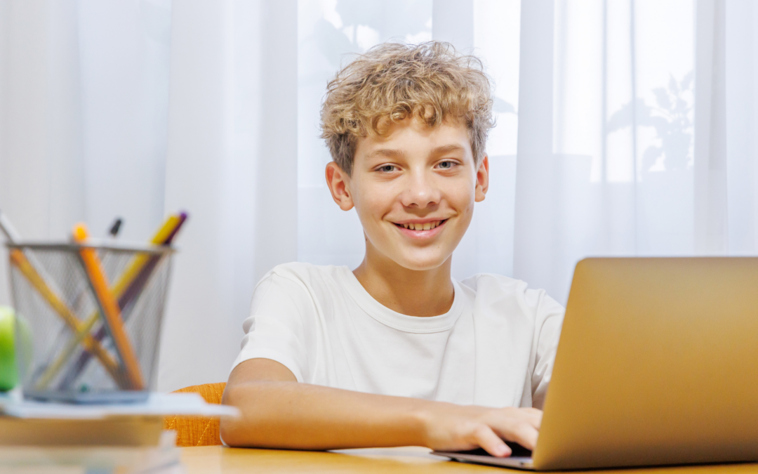 catholic homeschool boy writing a fantasy novel on his laptop