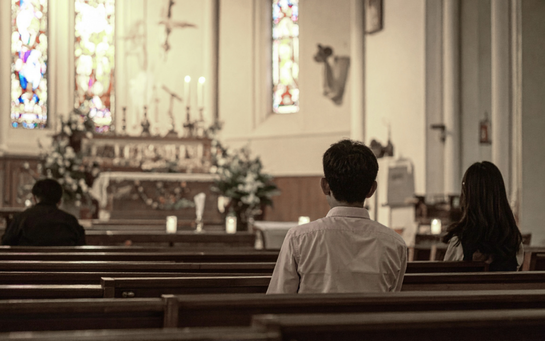 catholic homeschool teen boy sitting in church pew