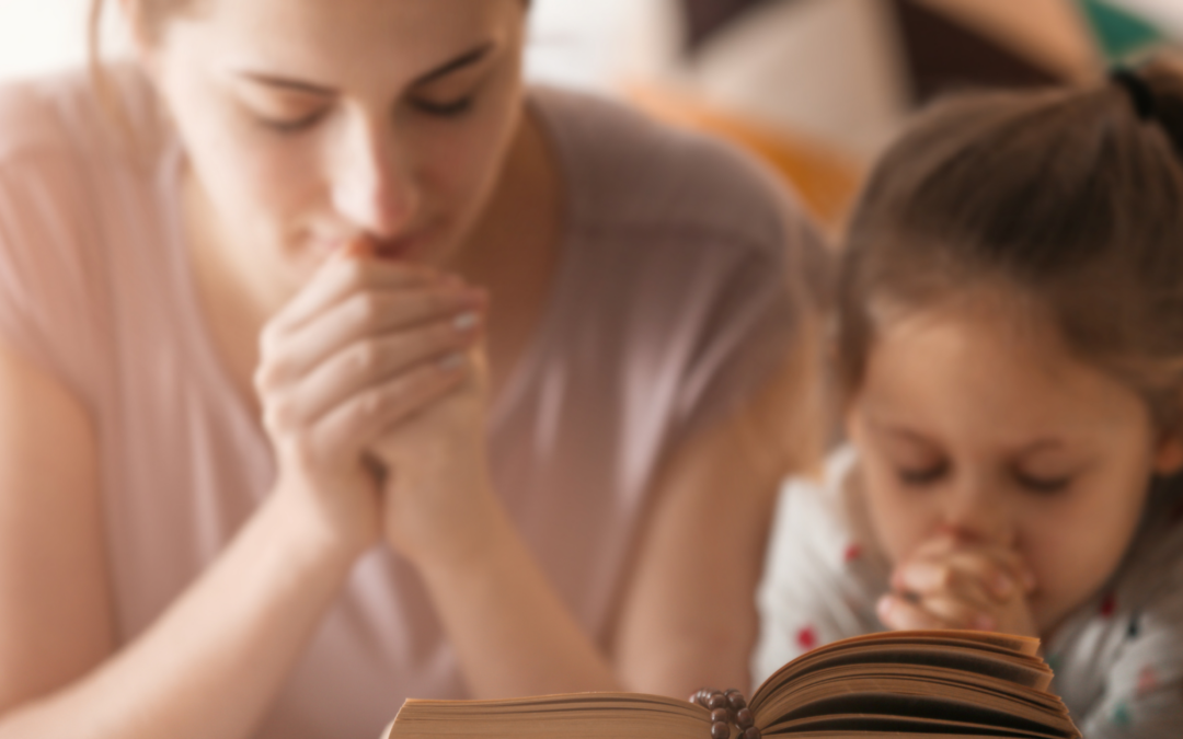 catholic homeschool mom and child praying