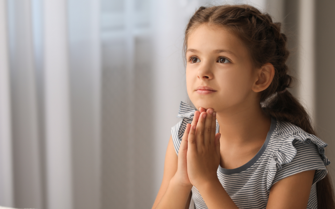 catholic homeschool girl praying at her bedside