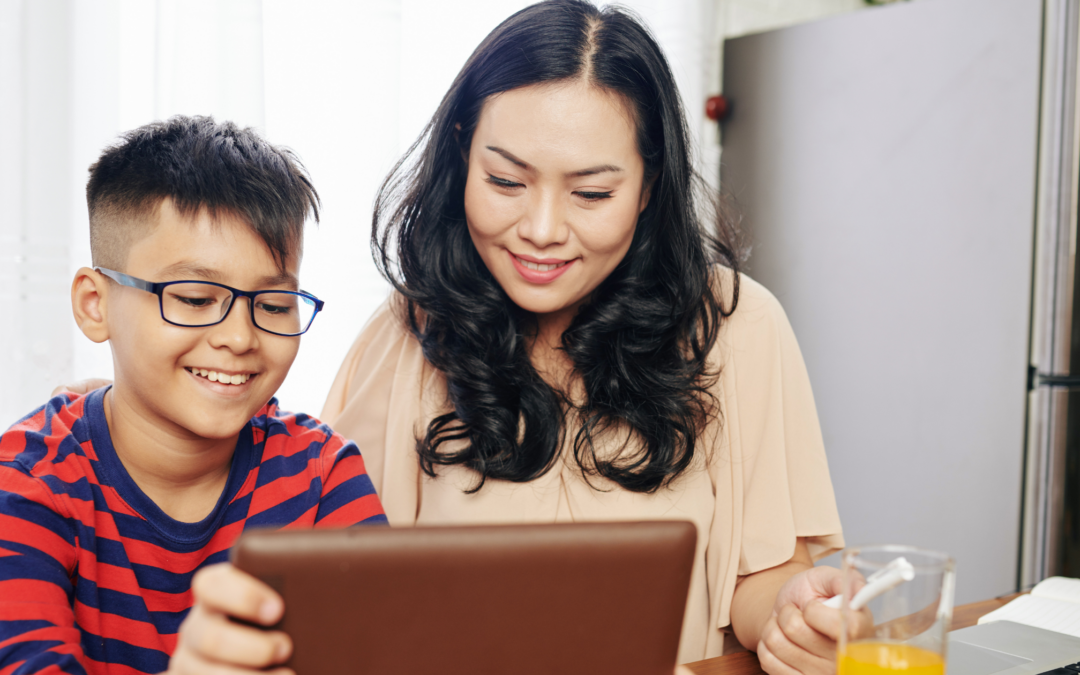 Catholic homeschool mom and son working on a lesson